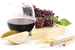 Photo of glass of wine, cheese and grapes.